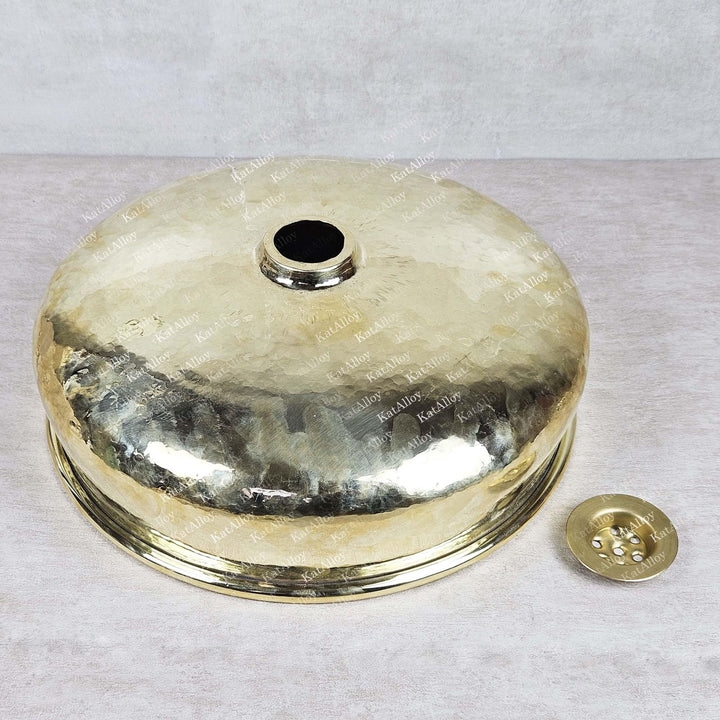 Brass or bronze metal cover with engraved text on a light gray background