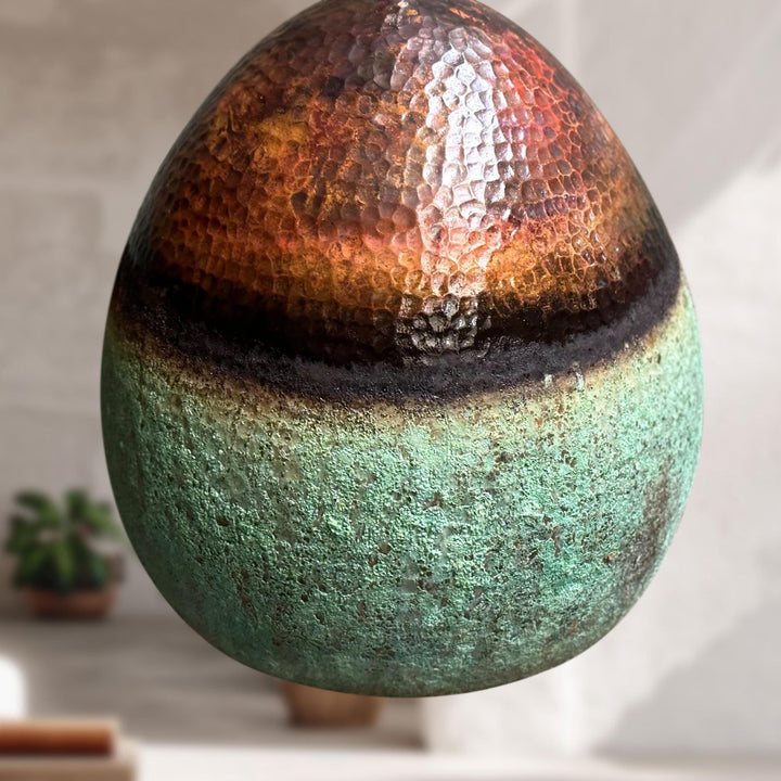 Decorative sphere with gradient colors on a neutral background