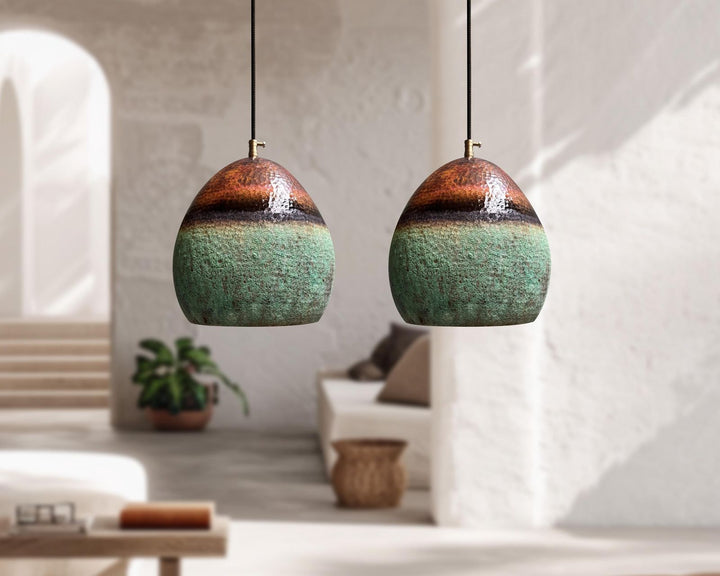 Two ceramic pendant lights hanging in a modern living room.