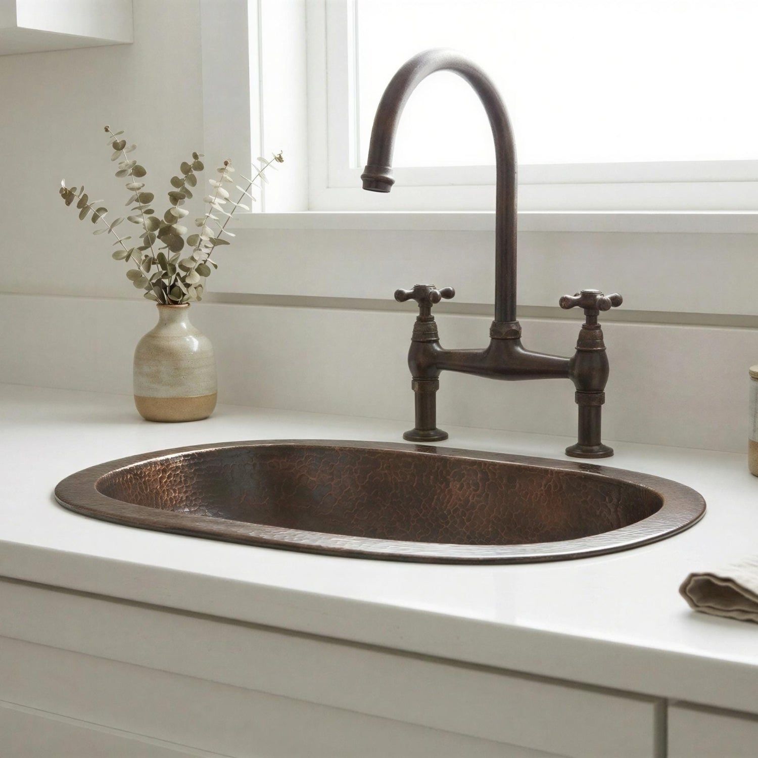 Brass sink with vintage-style faucet on a white countertop