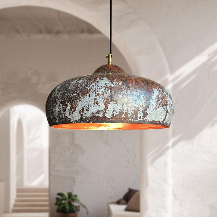 Rustic pendant light hanging in a softly lit room with architectural elements.