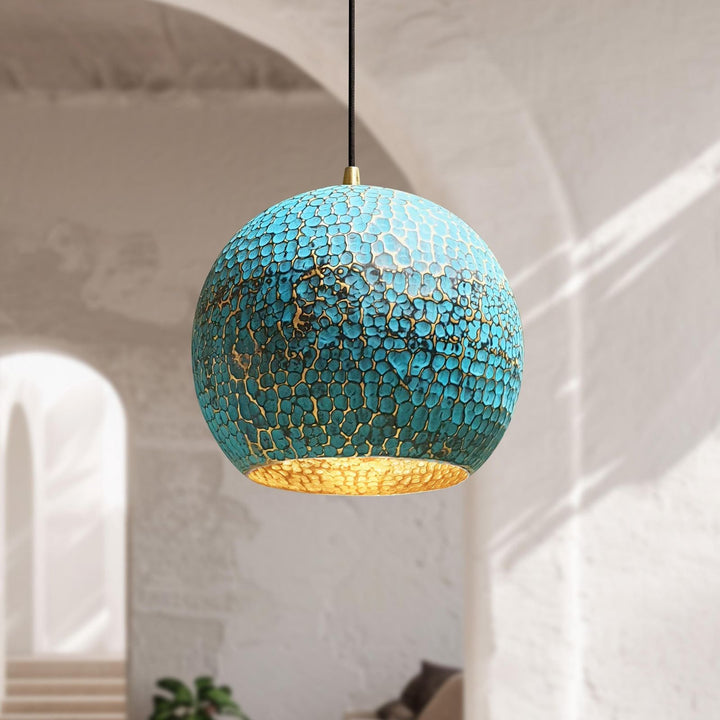 Turquoise pendant light with gold interior in a room setting