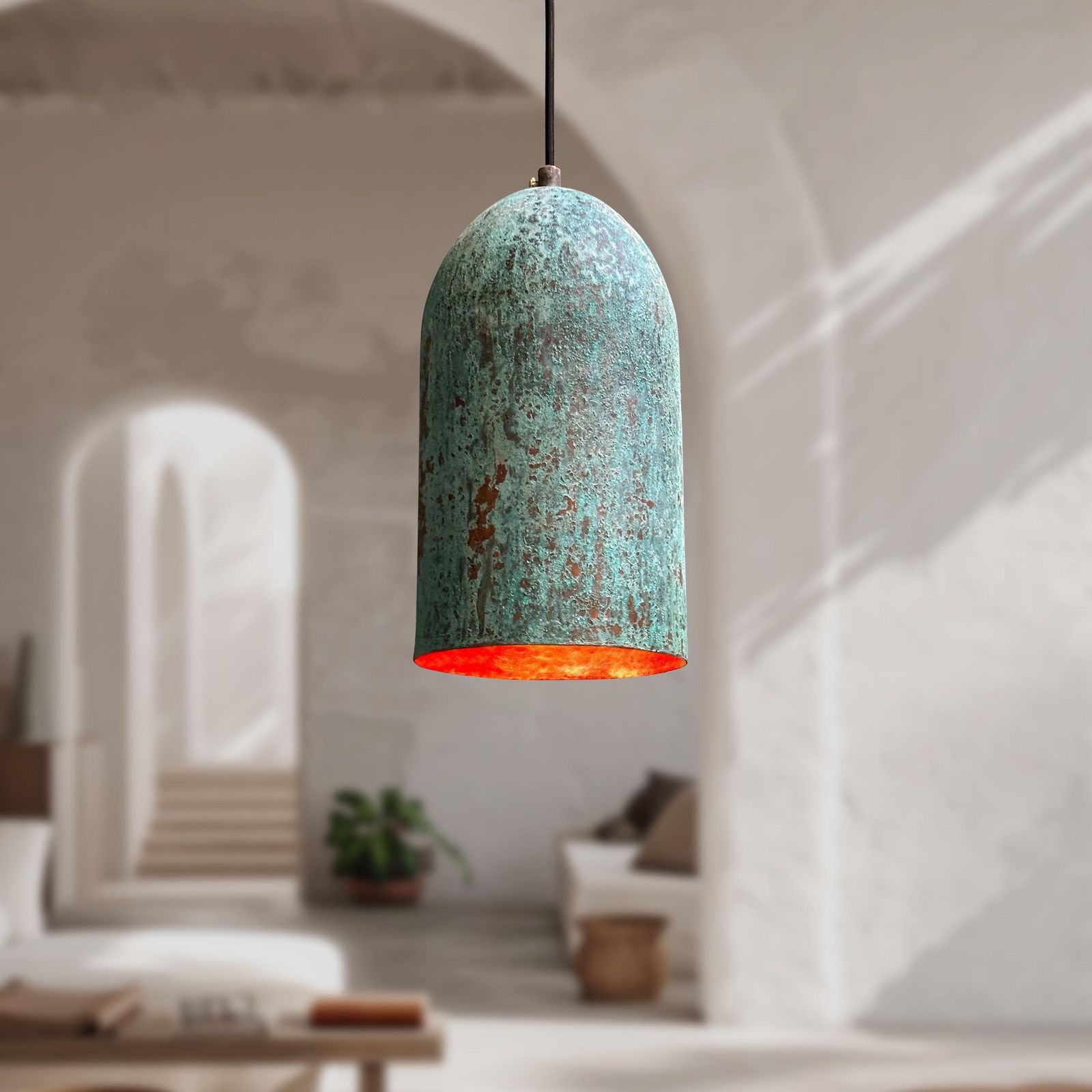 Decorative pendant light with a textured turquoise shade in a softly lit room.
