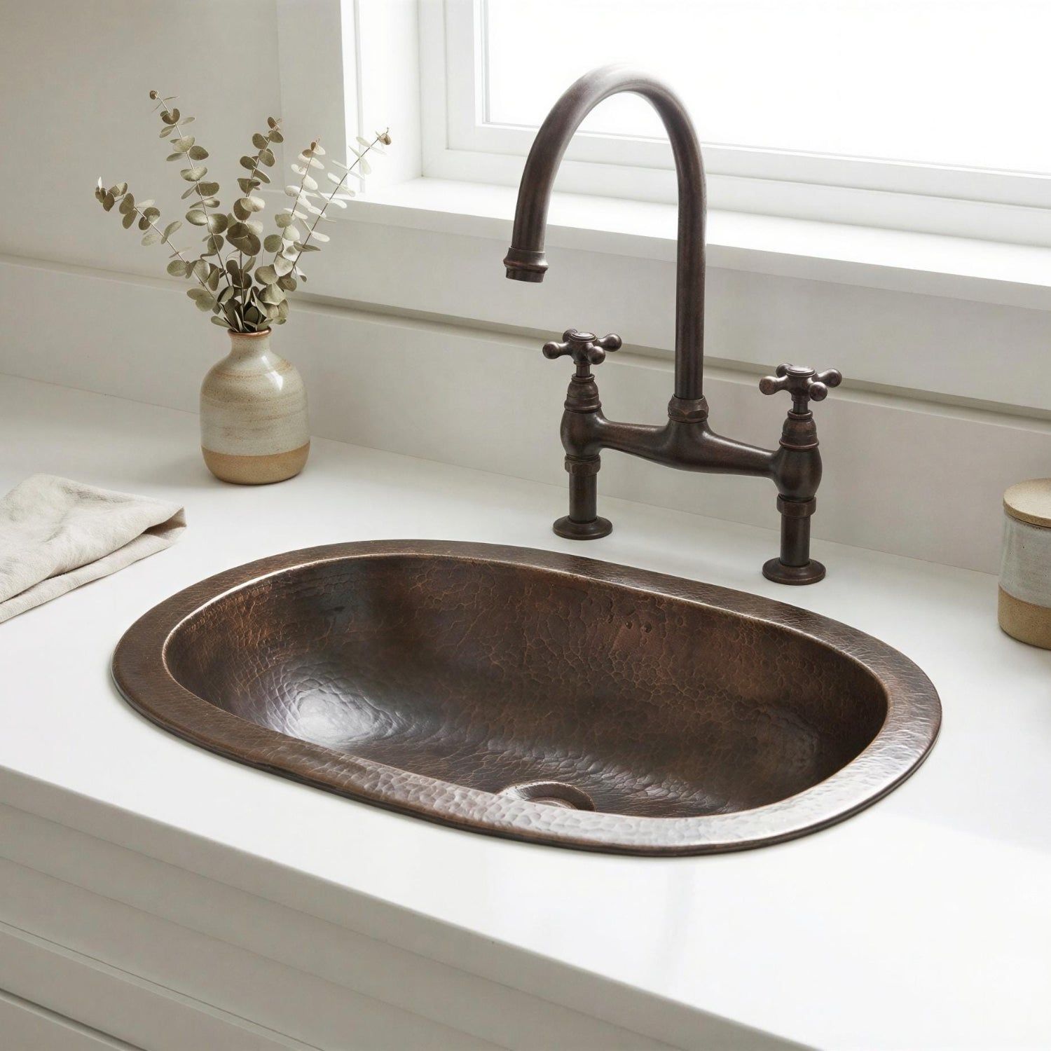 bronze brass sink with a vintage-style faucet in a kitchen setting.