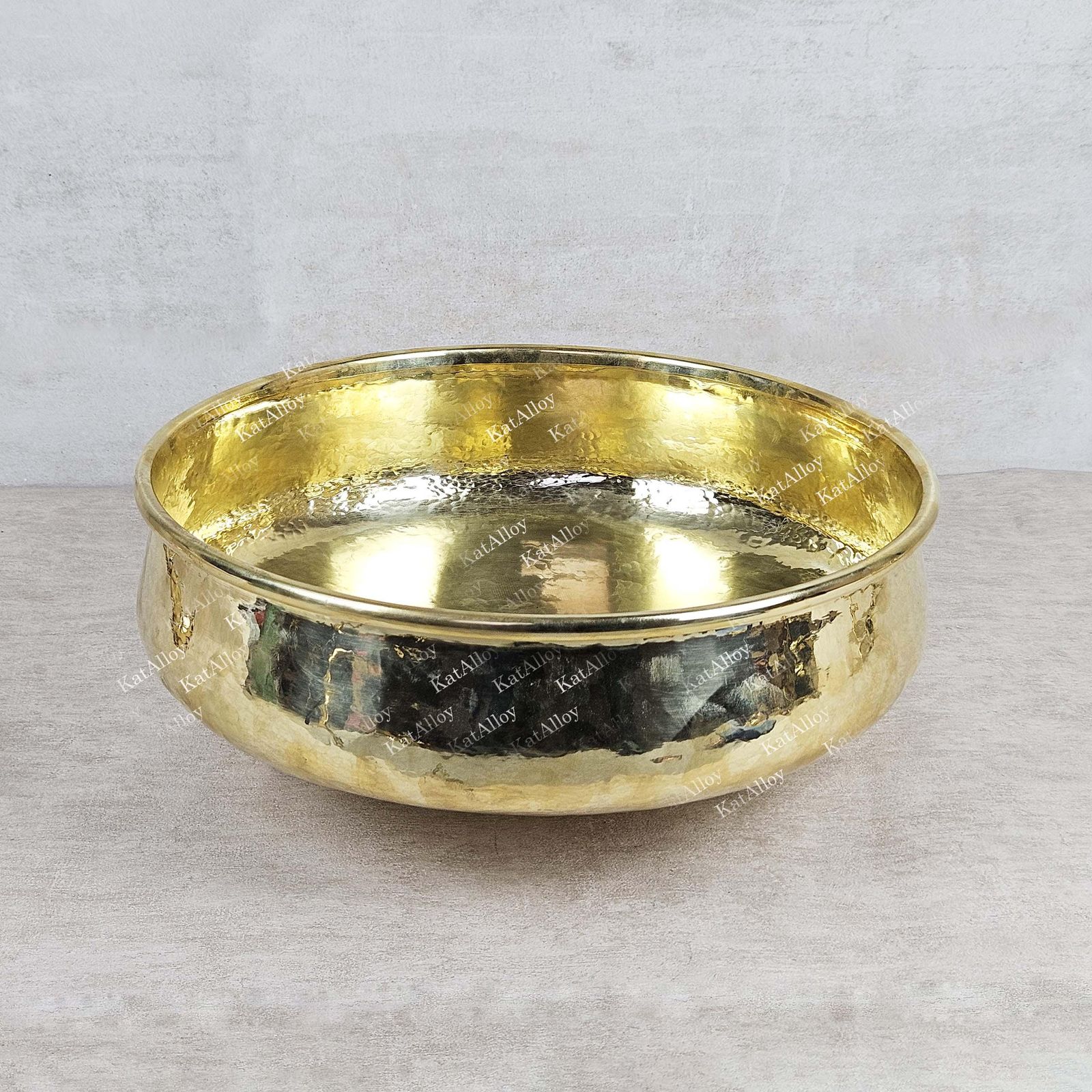 Gold bowl with engraved text on a light gray background