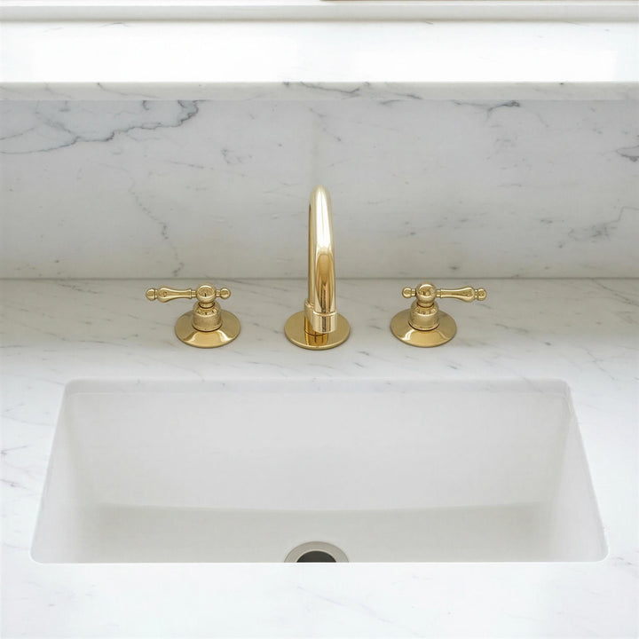 Gold faucet and handles on a marble countertop