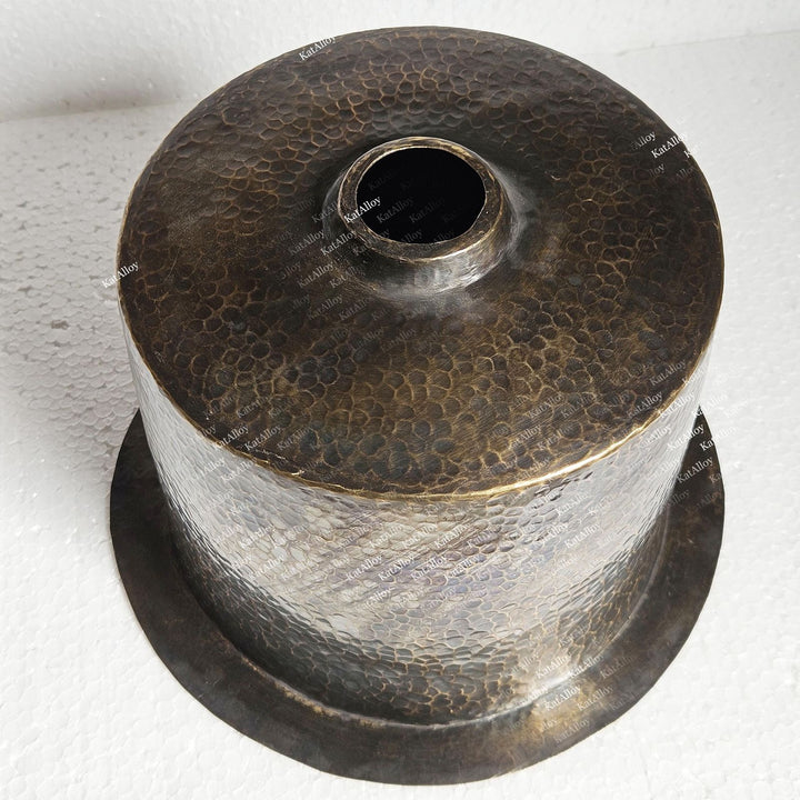 Metallic spool with textured surface on a white background