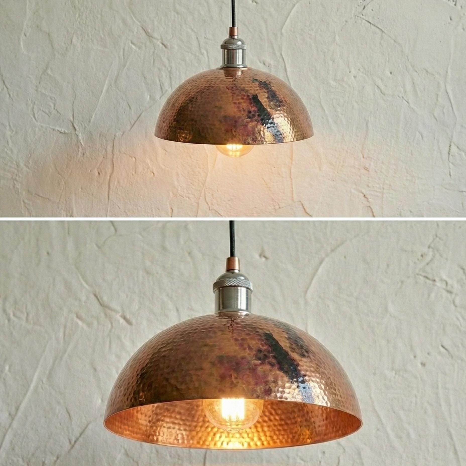 Copper pendant light fixture on a textured white wall.