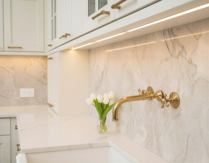 Kitchen backsplash with gold faucet and decorative elements