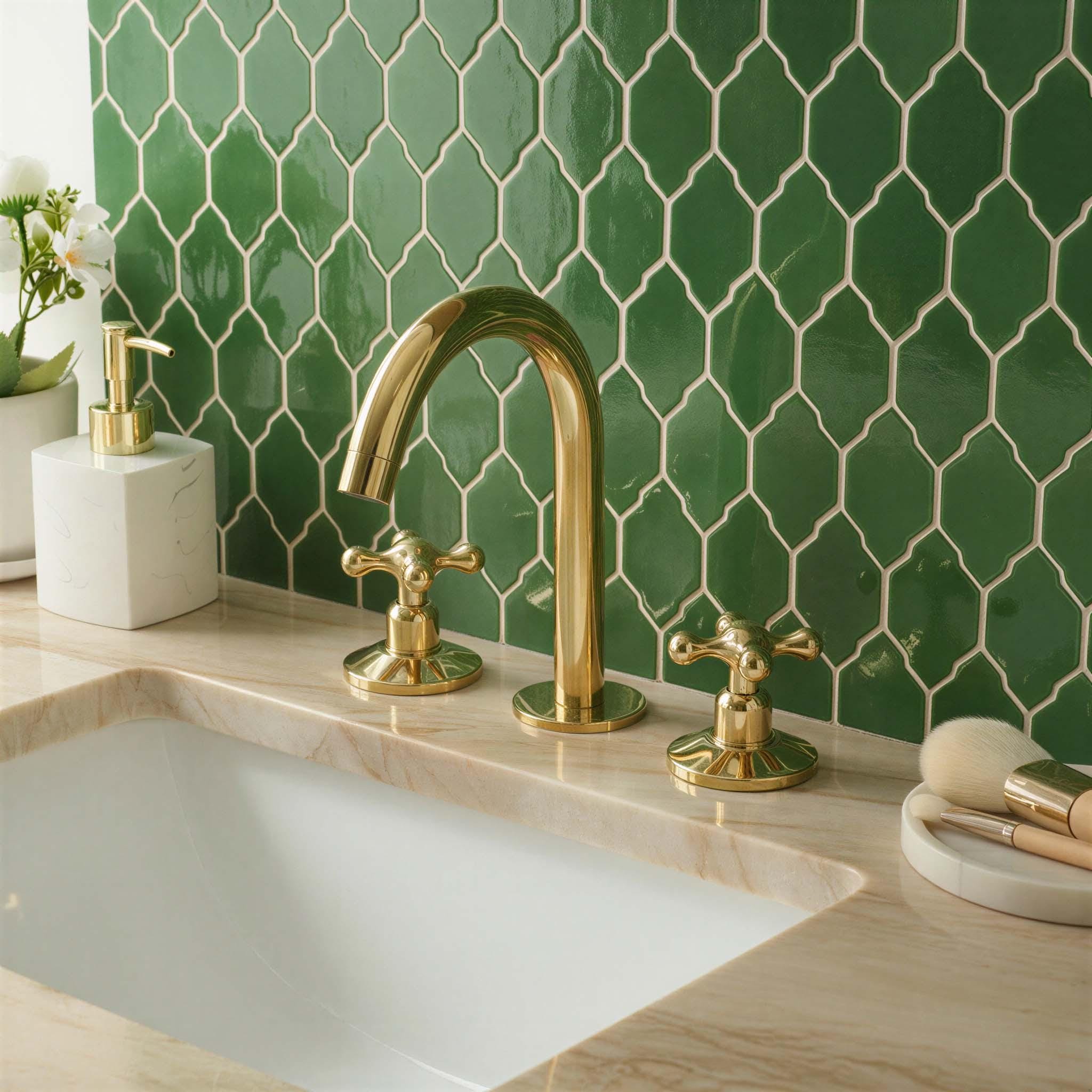 Bathroom sink with gold faucet and green tiled wall